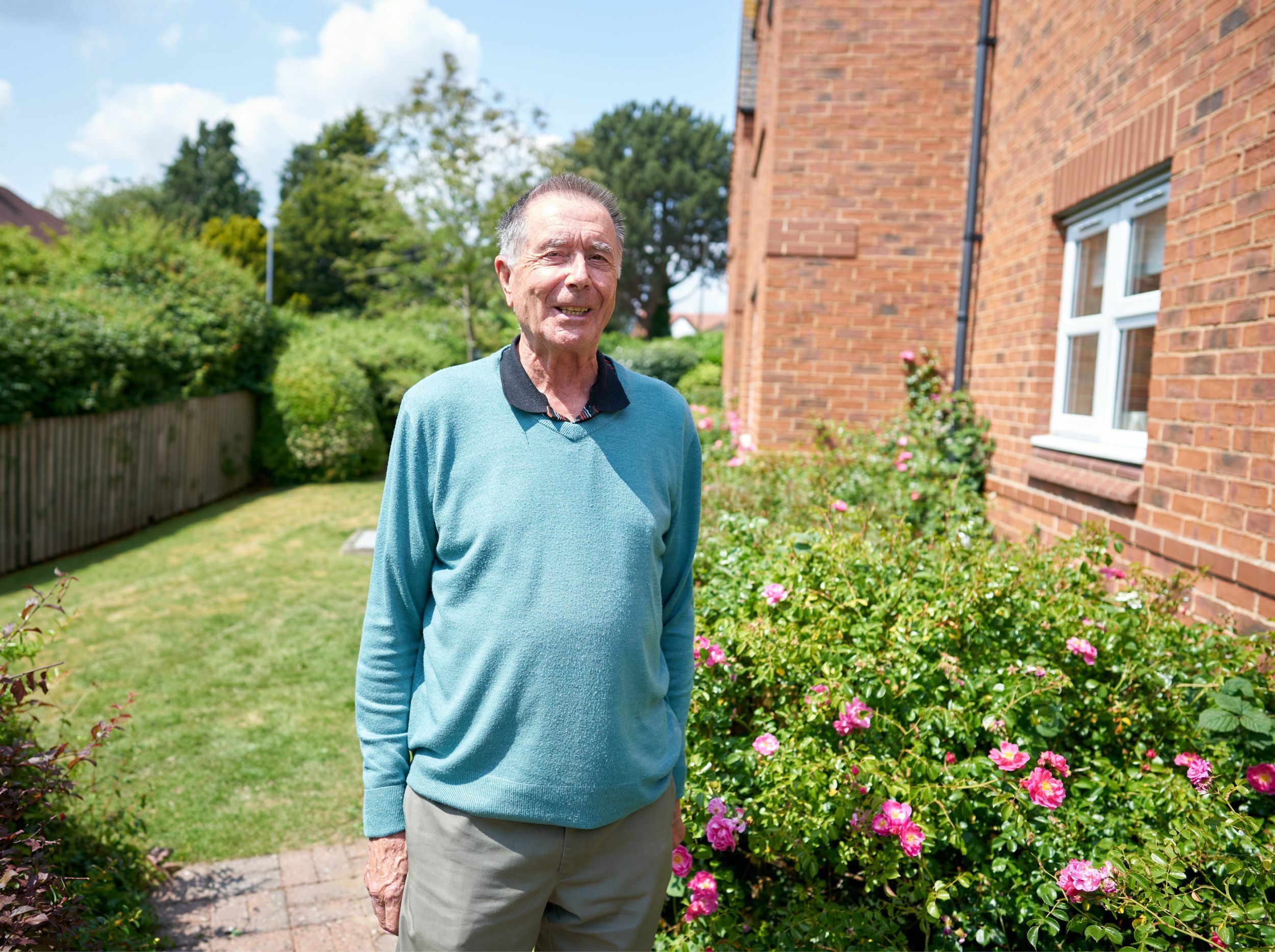 Senior man standing in a garden area