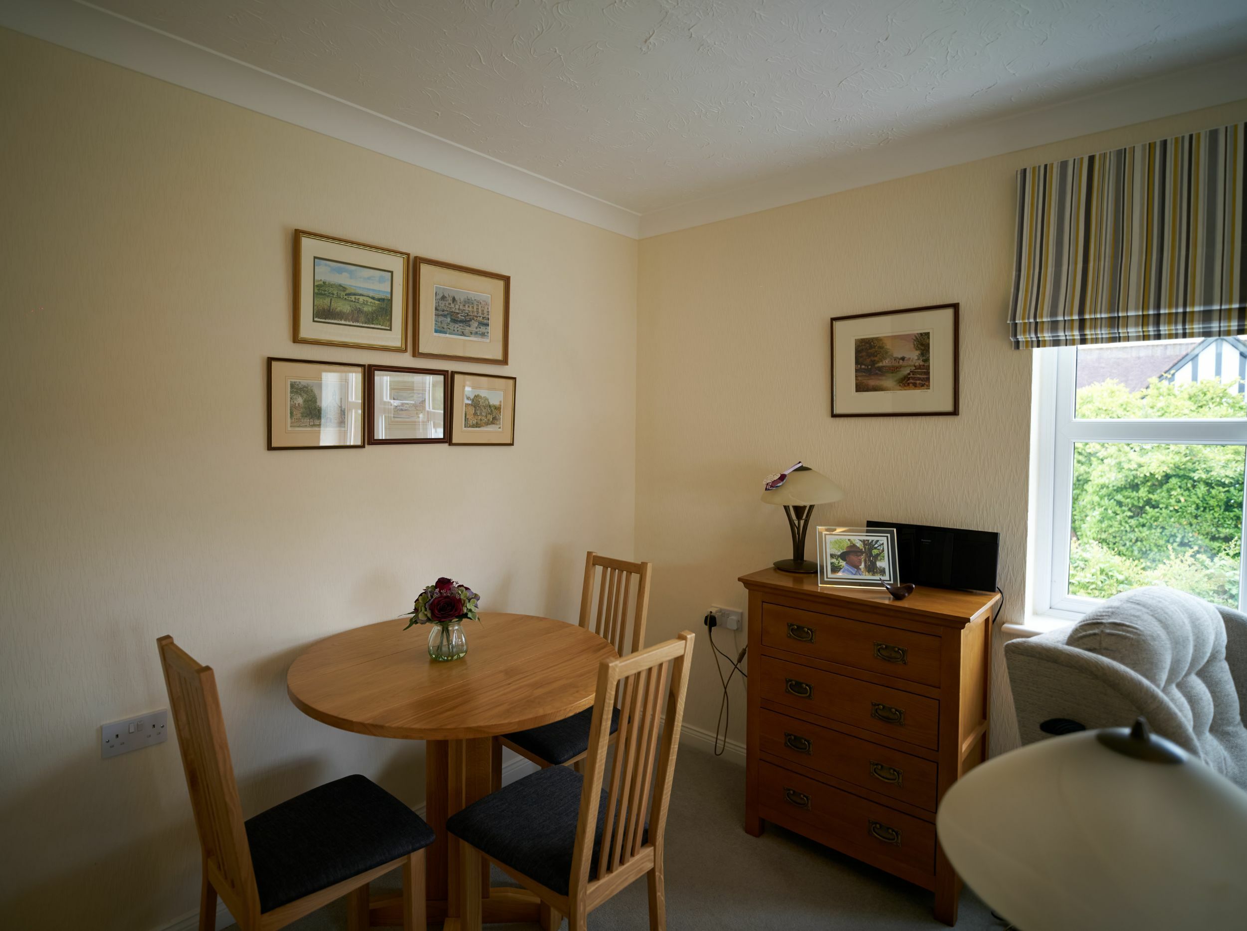 Cozy interior area with dining table and artwork.