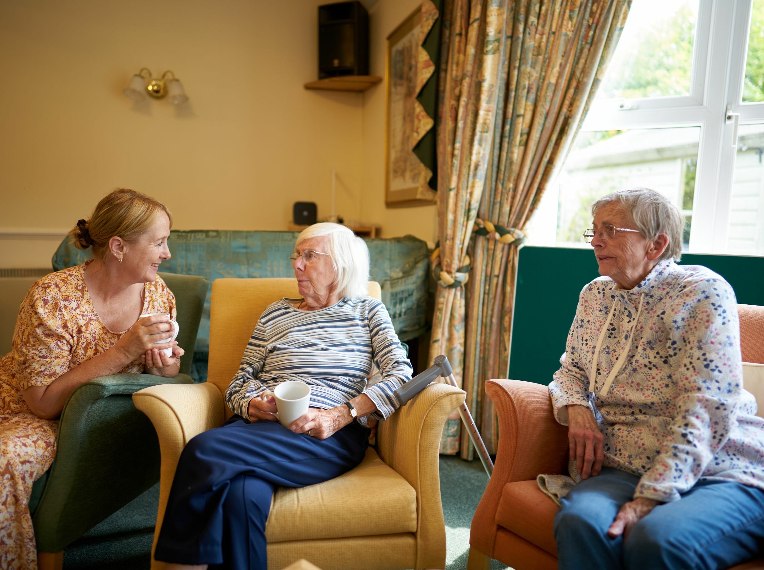 Residents enjoying a conversation in a common area.