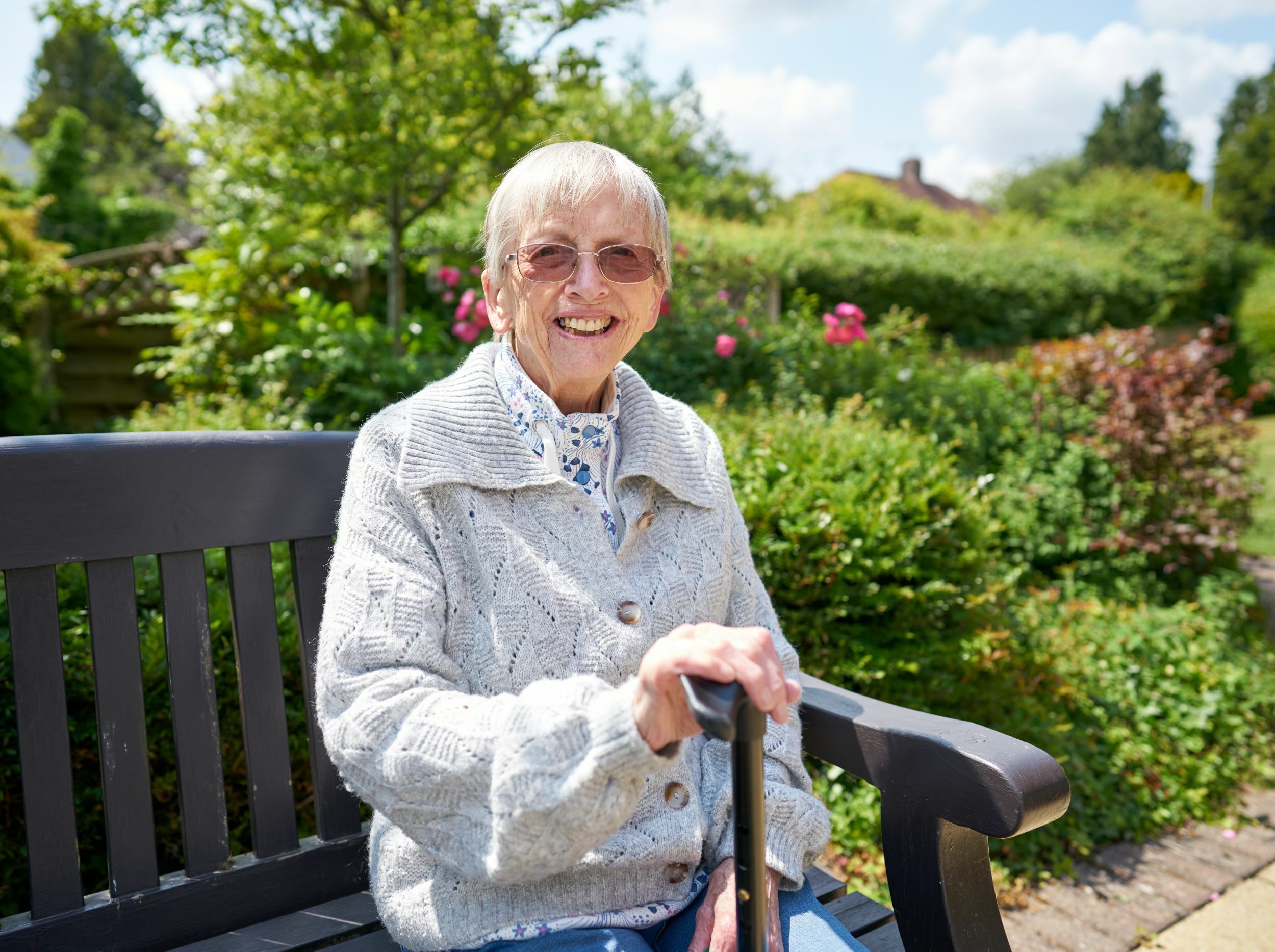 Senior woman enjoying a garden setting.