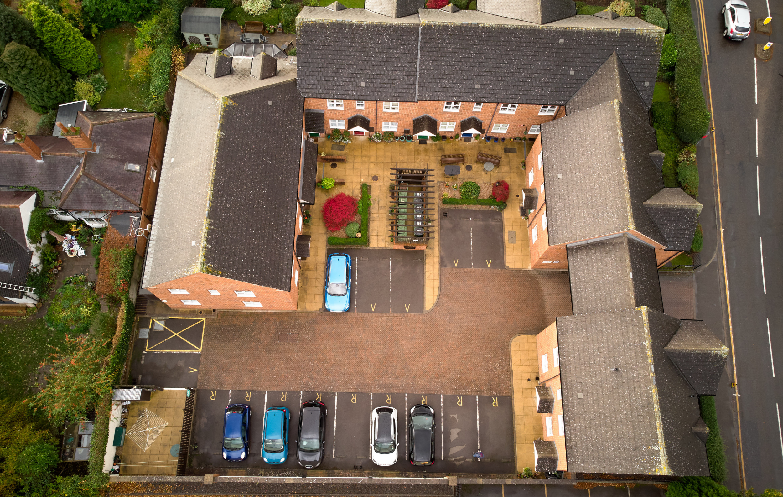 Aerial view of Pilgrim Gardens' exterior and parking area.