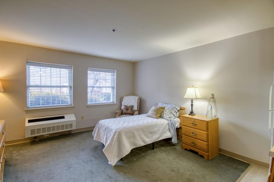 Brightly lit bedroom with a single bed and furniture