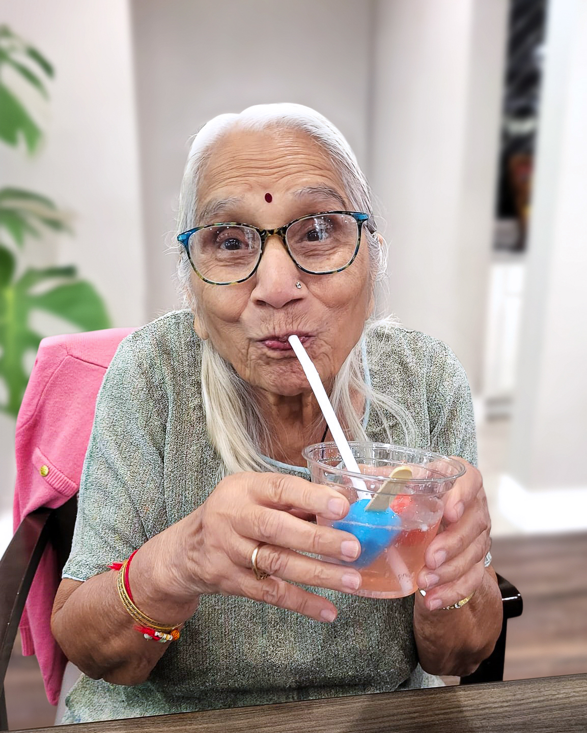 Resident enjoying a drink with a smile
