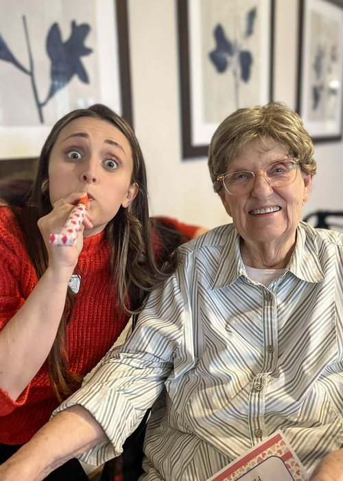 A resident and staff member celebrating together