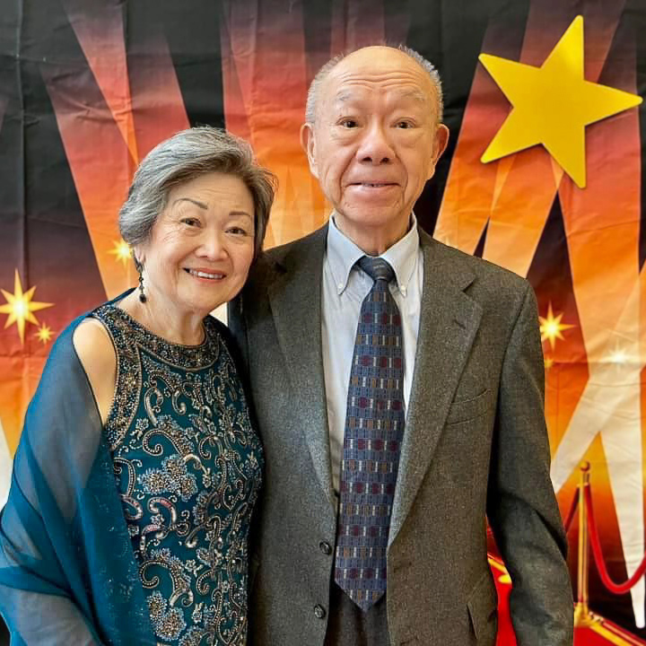 Two residents posing together at a celebration