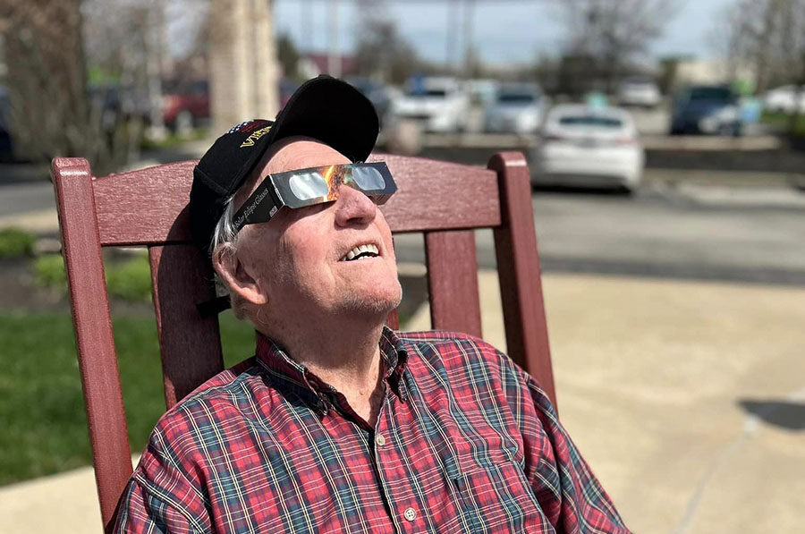 Resident enjoying the outdoors in a rocking chair