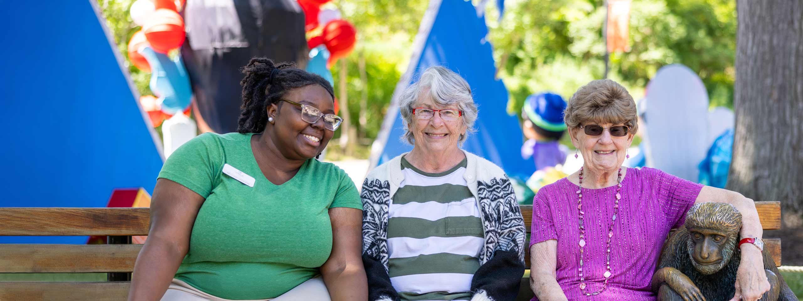 Three residents enjoying time outdoors in a garden setting
