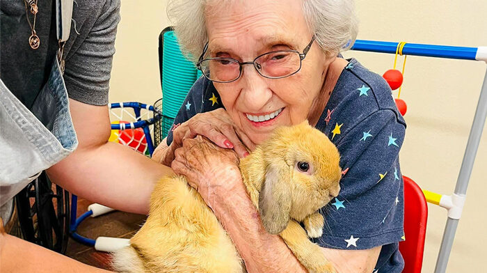 Resident hugging a bunny during a therapy session