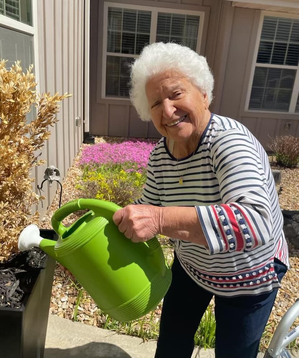 Resident gardening in a bright outdoor space