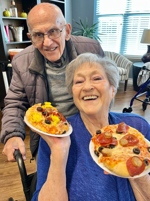 Residents enjoying pizza together in a common area