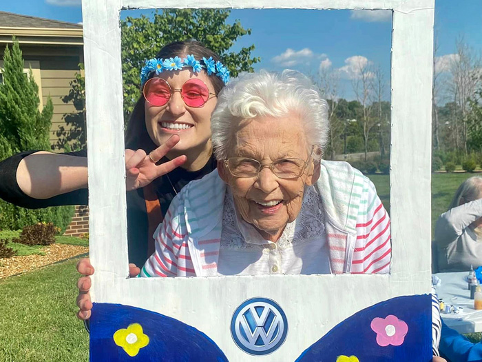 Resident and staff member posing together outdoors