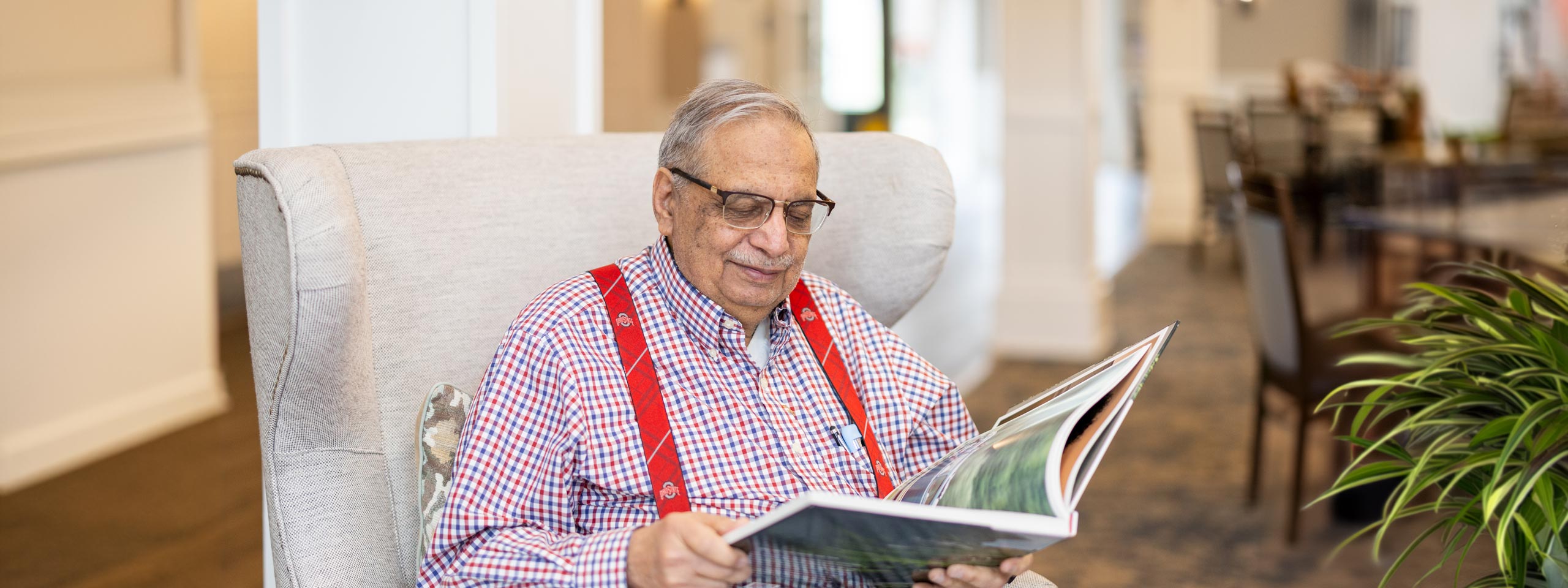 Senior resident reading in a cozy common area