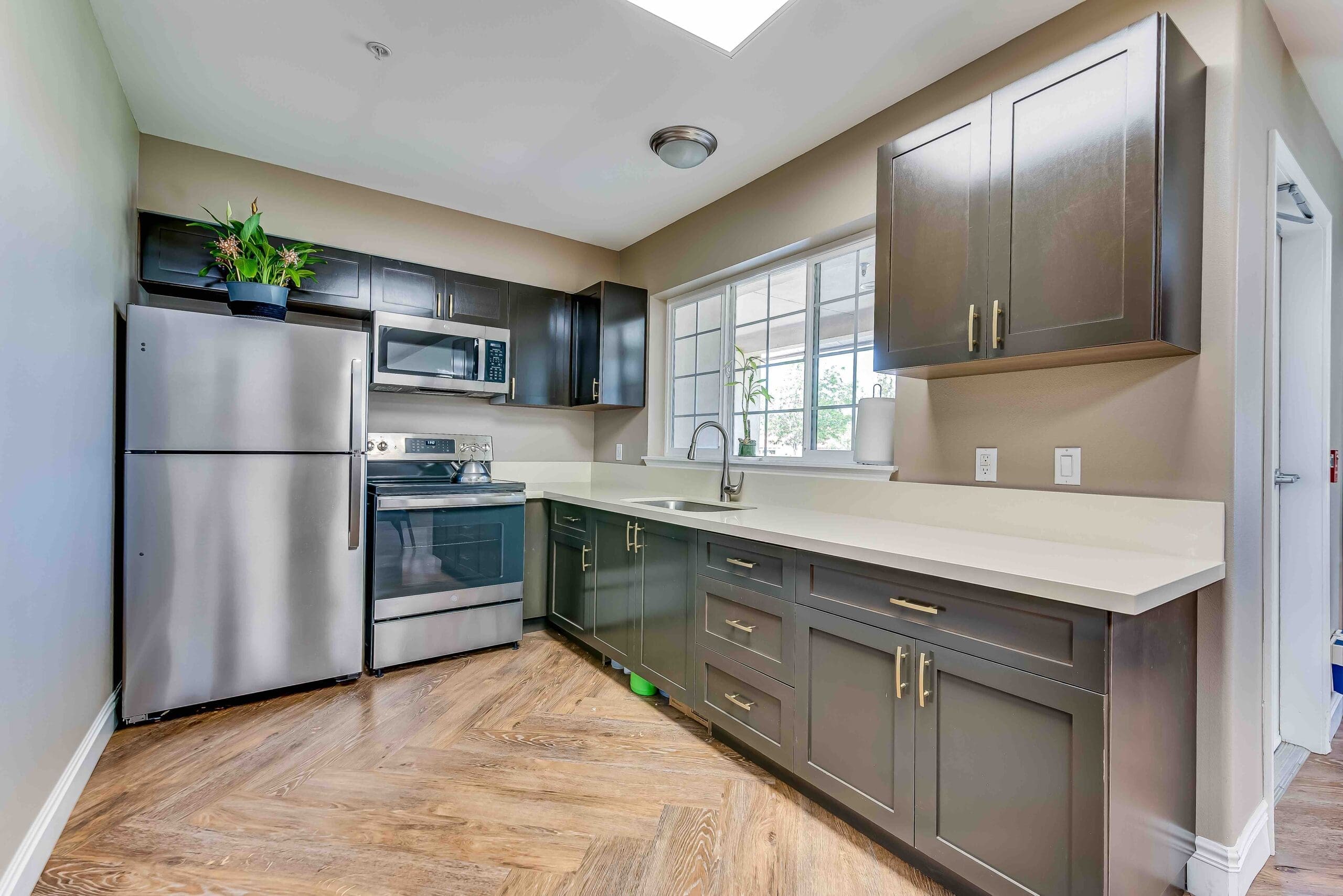 Modern kitchen with stainless steel appliances and a window