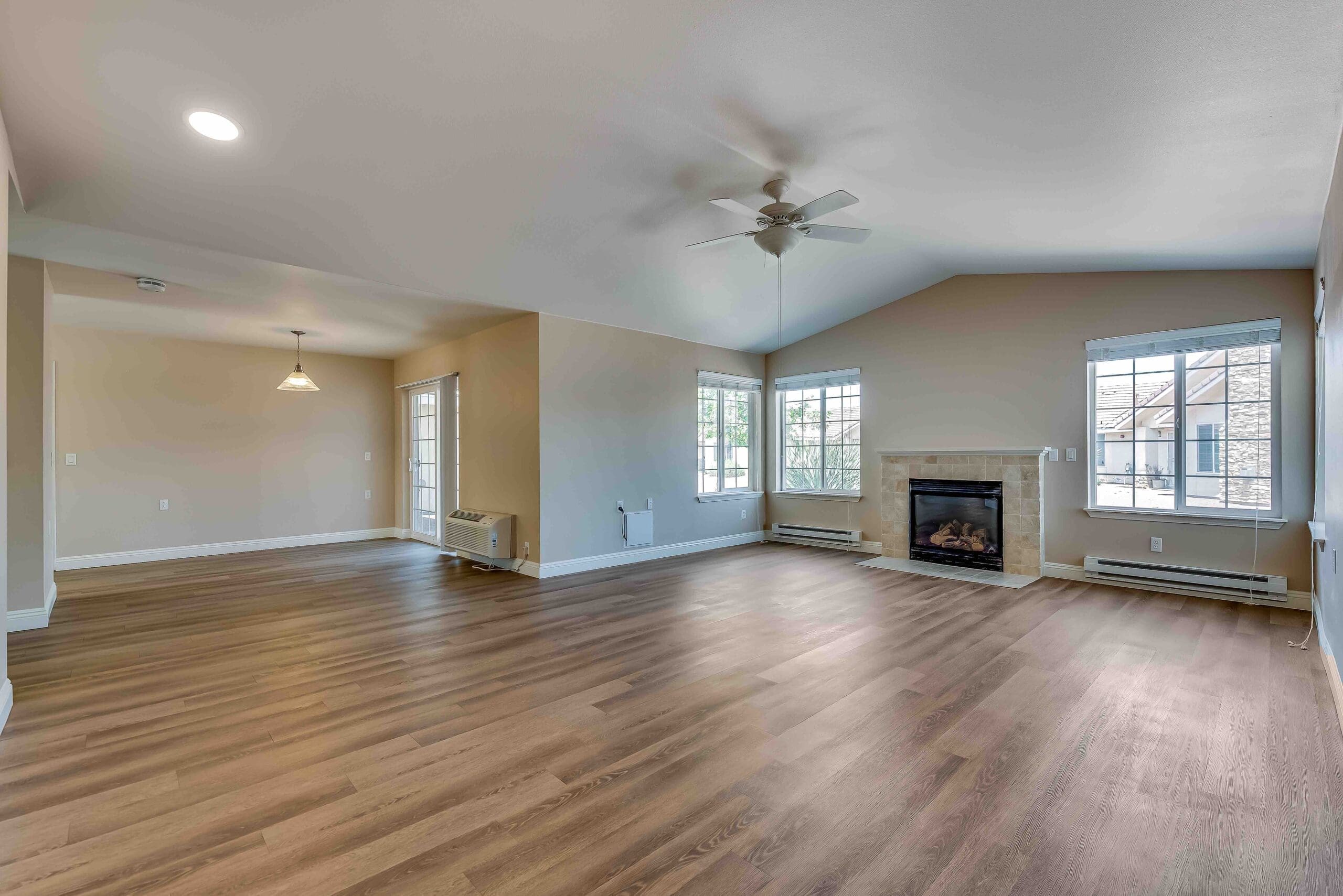 Bright and spacious living area with wood flooring