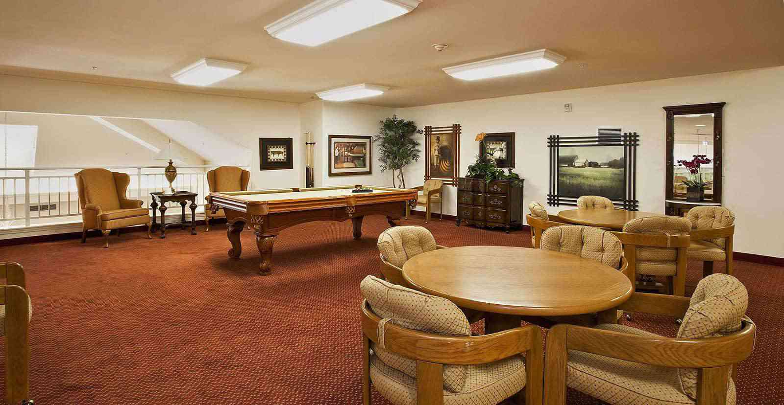 Interior view of a common area with seating and a pool table