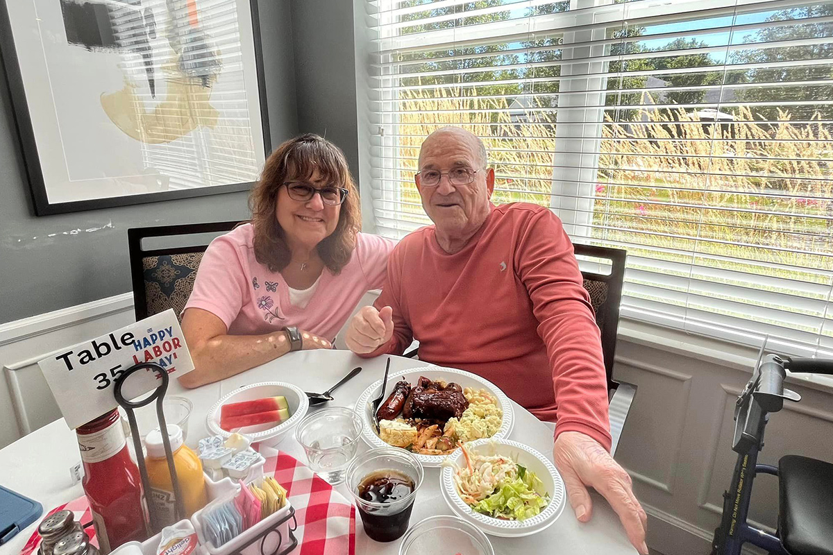 Residents enjoying a meal together at a dining table