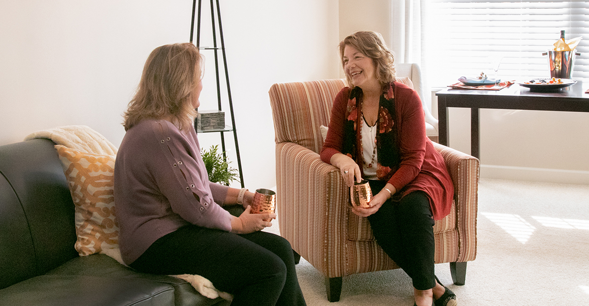 Residents enjoying conversation in a cozy living space