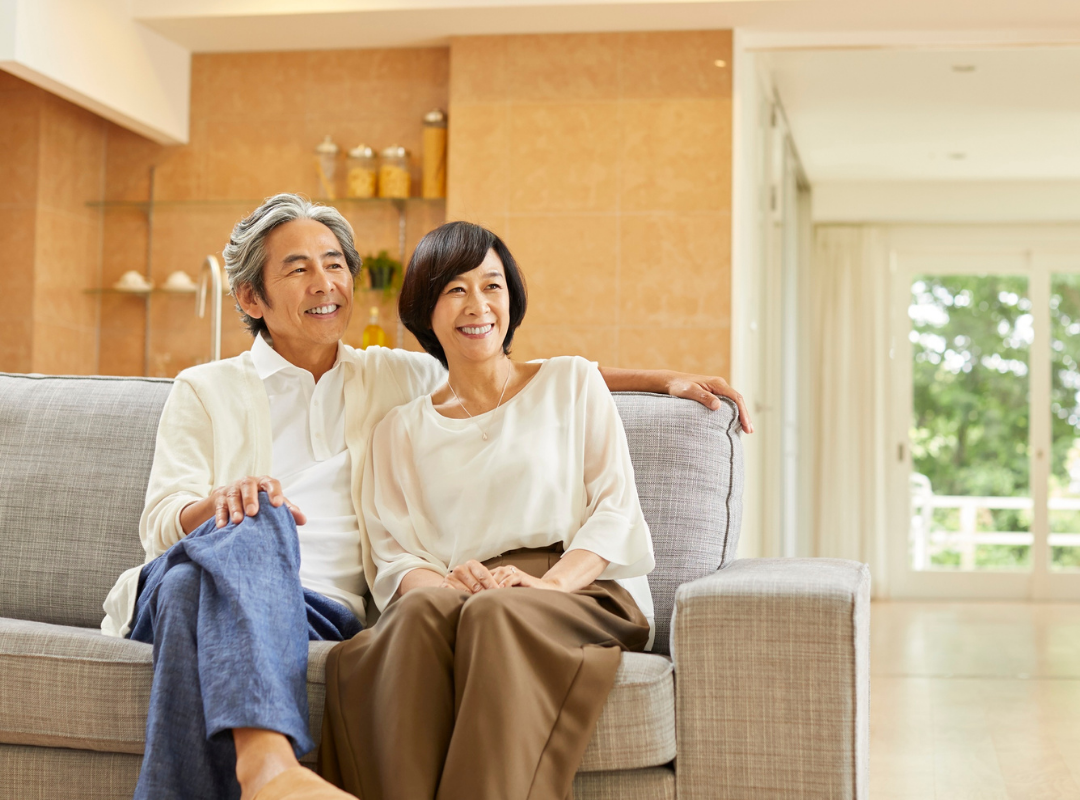 Happy couple relaxing in a bright common area