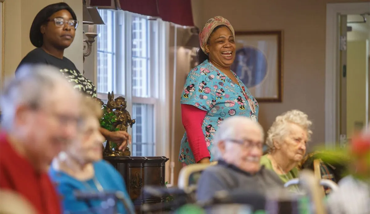 Residents and staff engaging in activity in a common area