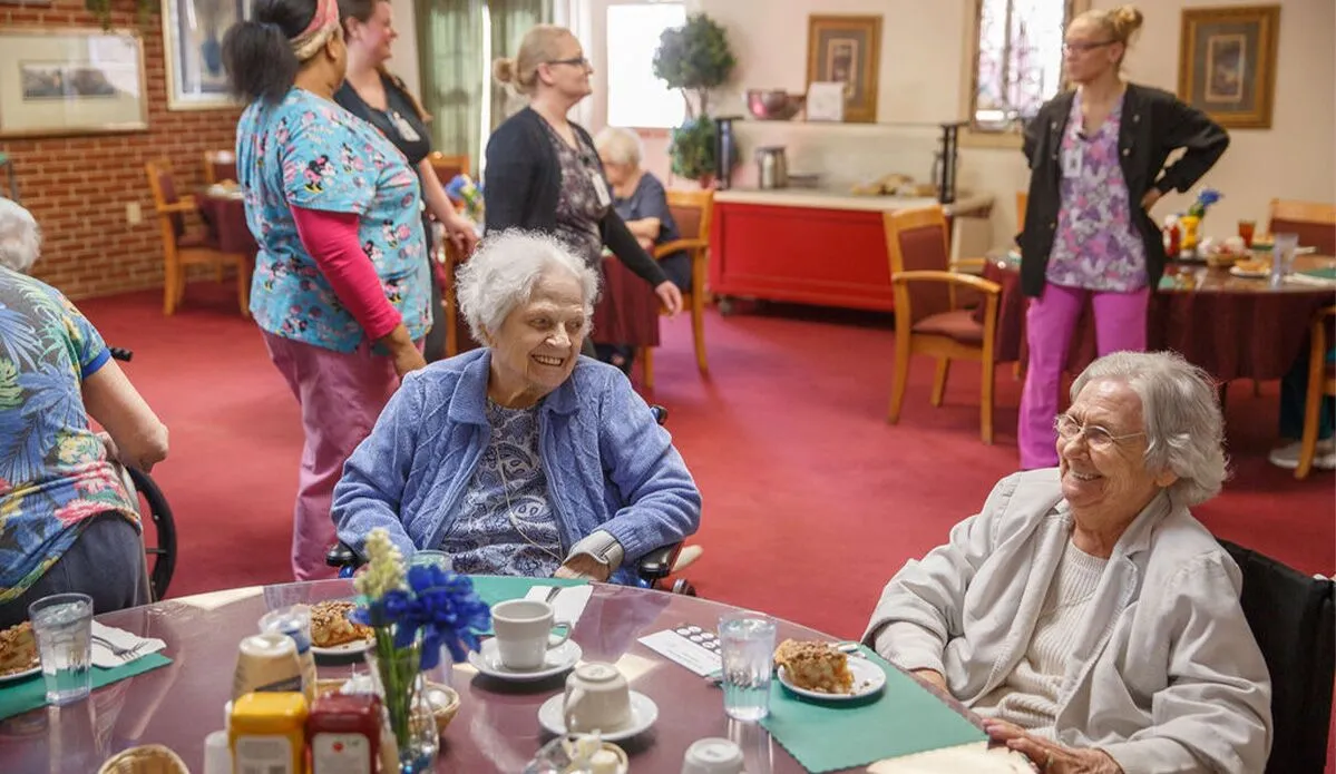 Residents enjoying a snack and conversation in common area
