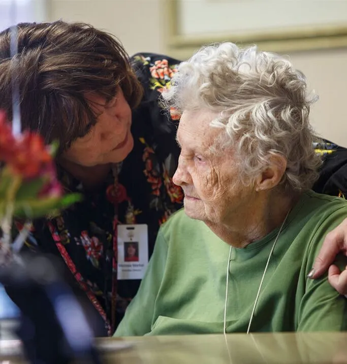 Staff interacting with a resident in a cozy environment