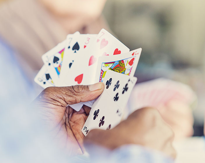 A hand holding playing cards during a game