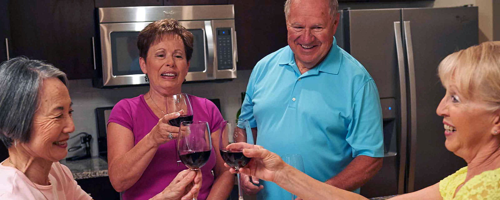 Residents celebrating with drinks in a common area