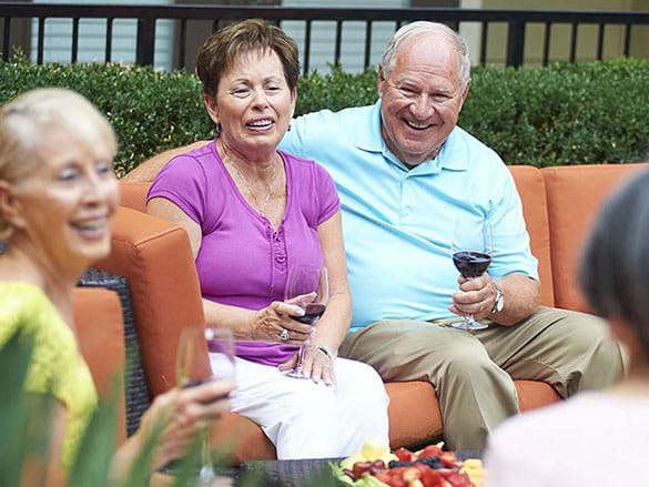 Residents enjoying drinks in an outdoor lounge area