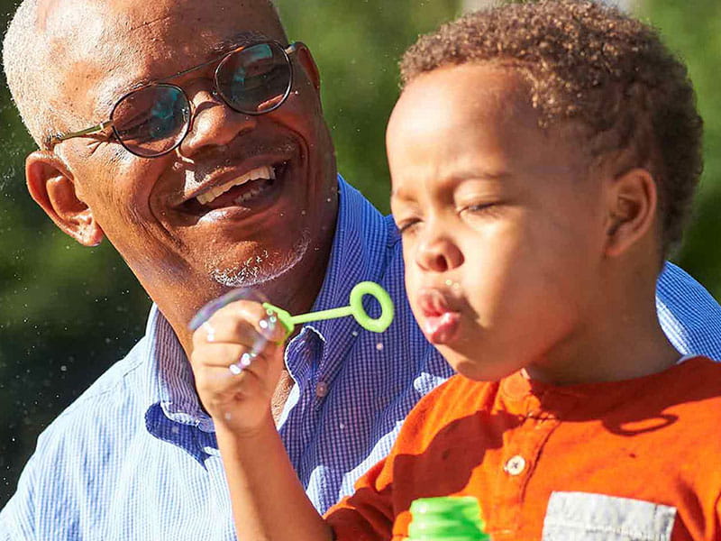 A senior man enjoying time with a young boy outdoors