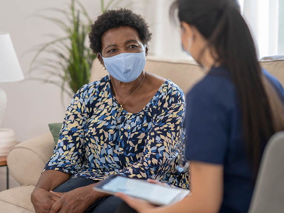 A resident and a staff member having a conversation
