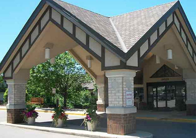 Entrance of a senior living facility with landscaping