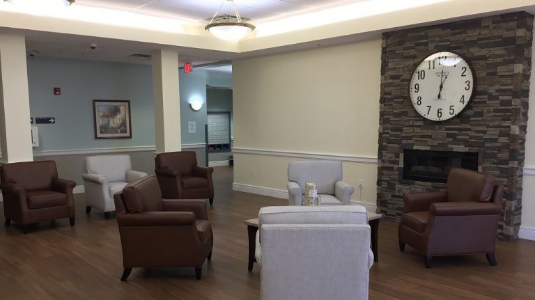 Common area with comfortable seating and a clock