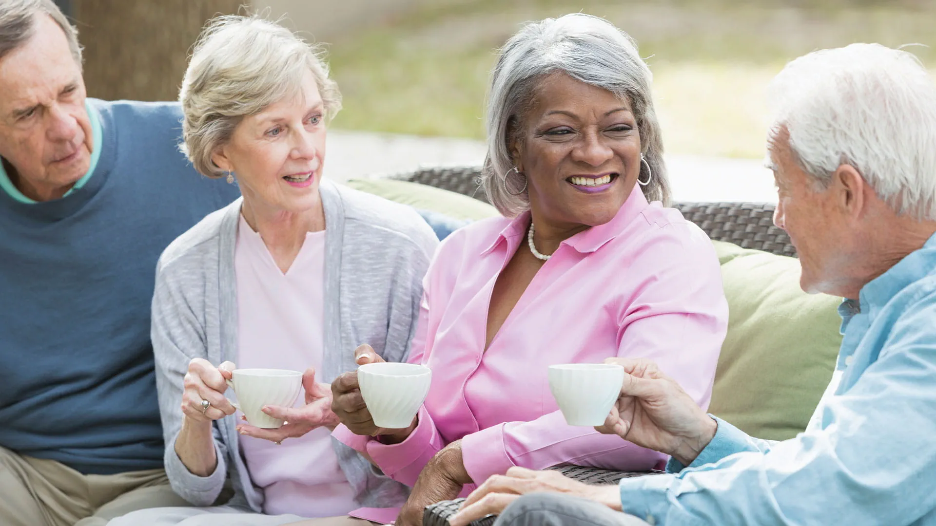 Residents enjoying tea in an outdoor lounge area