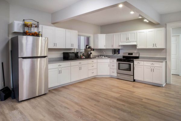 Bright, modern kitchen with white cabinets and stainless steel appliances