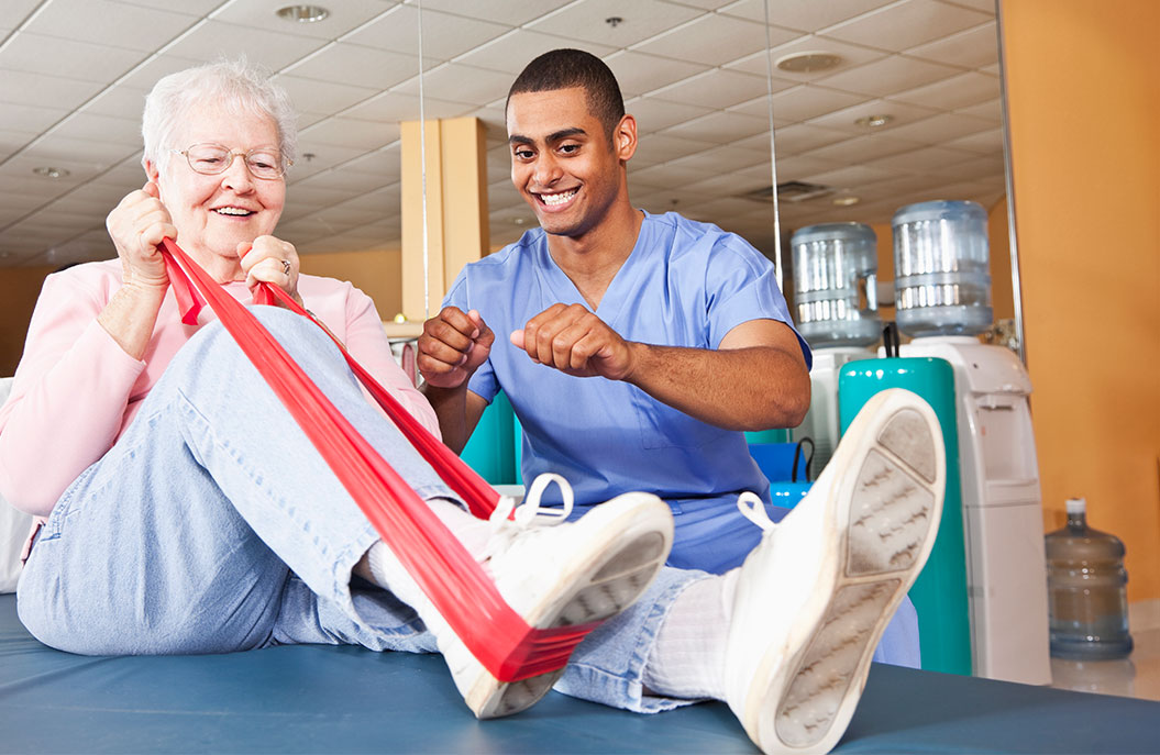 Resident and staff member engaging in therapy exercise