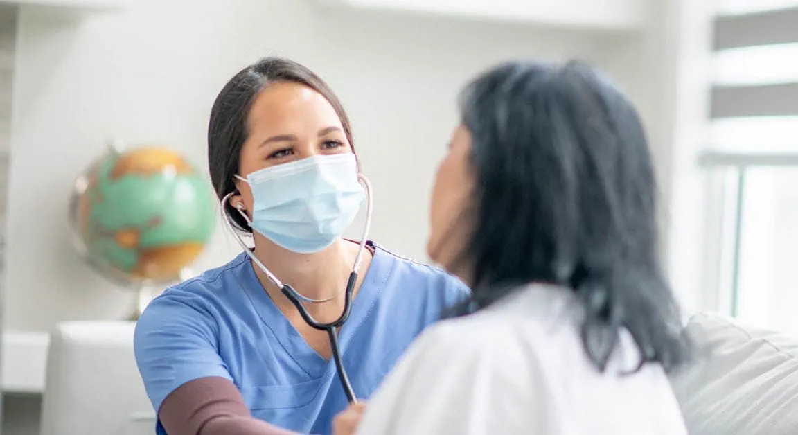 A healthcare worker interacting with a resident