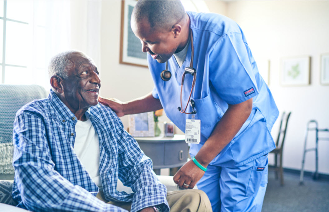 Caregiver interacting with a resident in a warm environment
