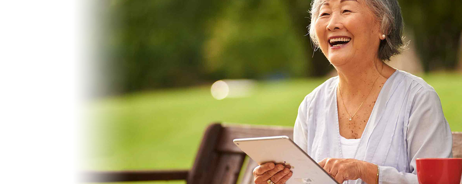 Senior woman using a tablet in a garden