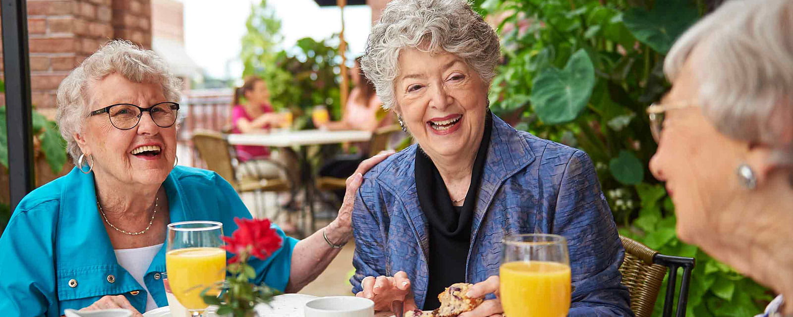 Residents enjoying drinks and snacks on a patio