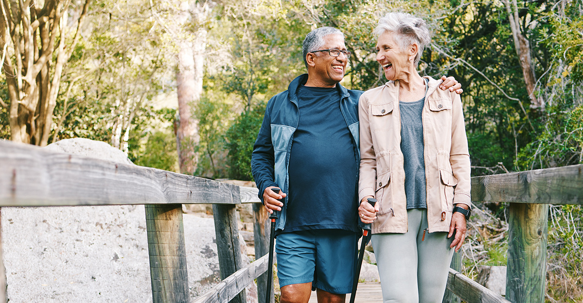 Couple walking outdoors on a bridge in nature