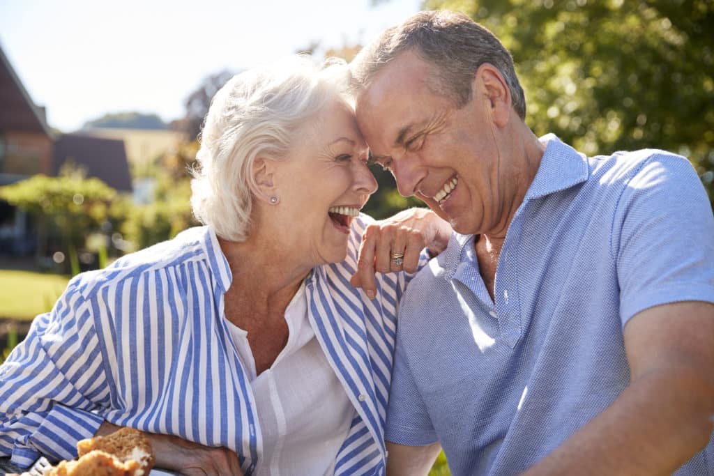 Happy residents enjoying food outdoors