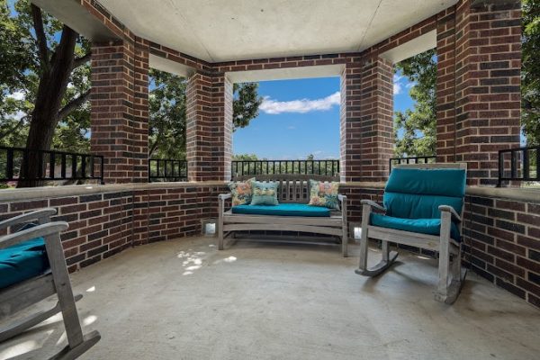 Outdoor seating area with rocking chairs and cushions