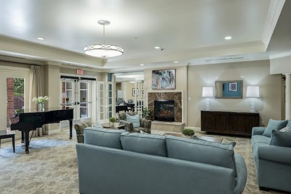 Bright common area with seating and a piano