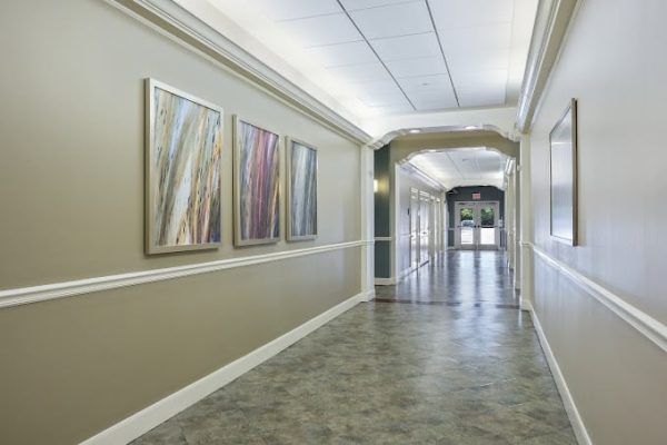 Well-lit corridor with artwork on the walls