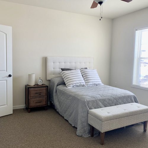 Private resident room with a bed and nightstand