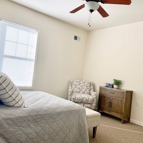 Cozy private resident room with bed and chair