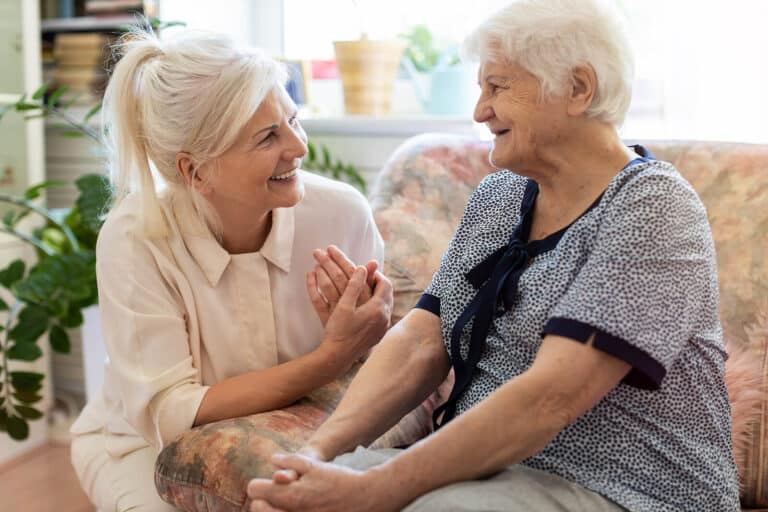 Caregiver interacting with a senior resident in a cozy setting