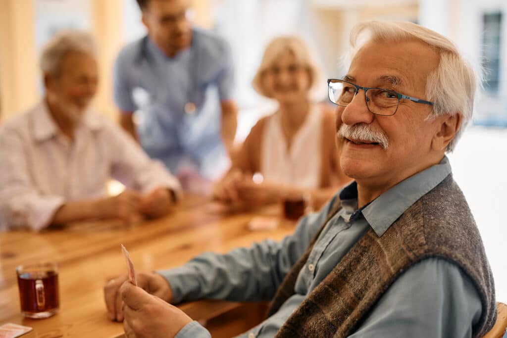Residents enjoying a card game in a common area