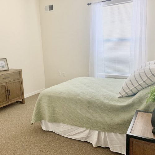 Private bedroom with a bed and dresser