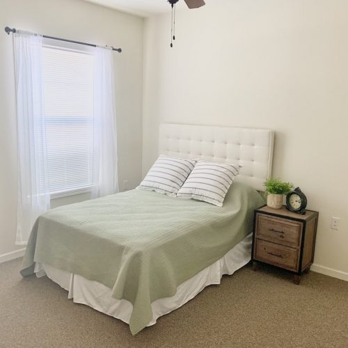 Cozy private bedroom with a neatly made bed
